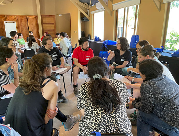 Grupos de personas conversando sentadas en círculo.