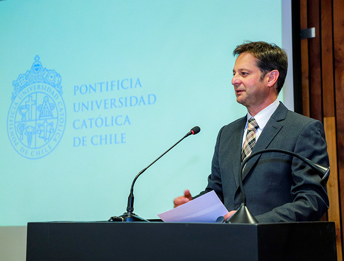 Vicerrector de Investigación UC Pedro Bouchon en la testera con el logo UC de fondo