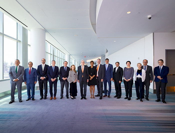 Fifteen members of the Hemispheric University Consortium are posing for the camera. Four of them are women.