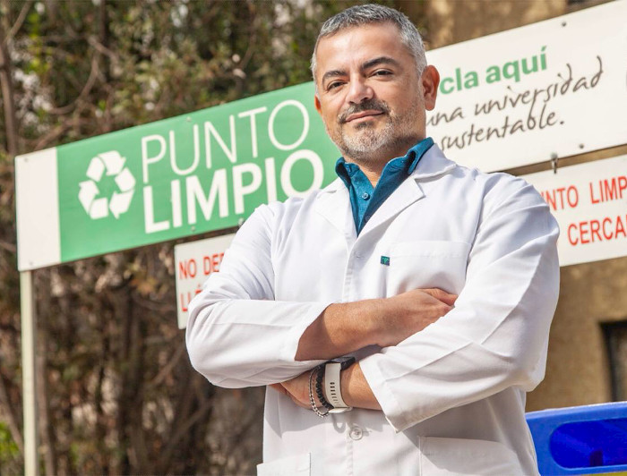 Primer plano del investigador César Sáez, frente a un punto limpio de la Universidad.
